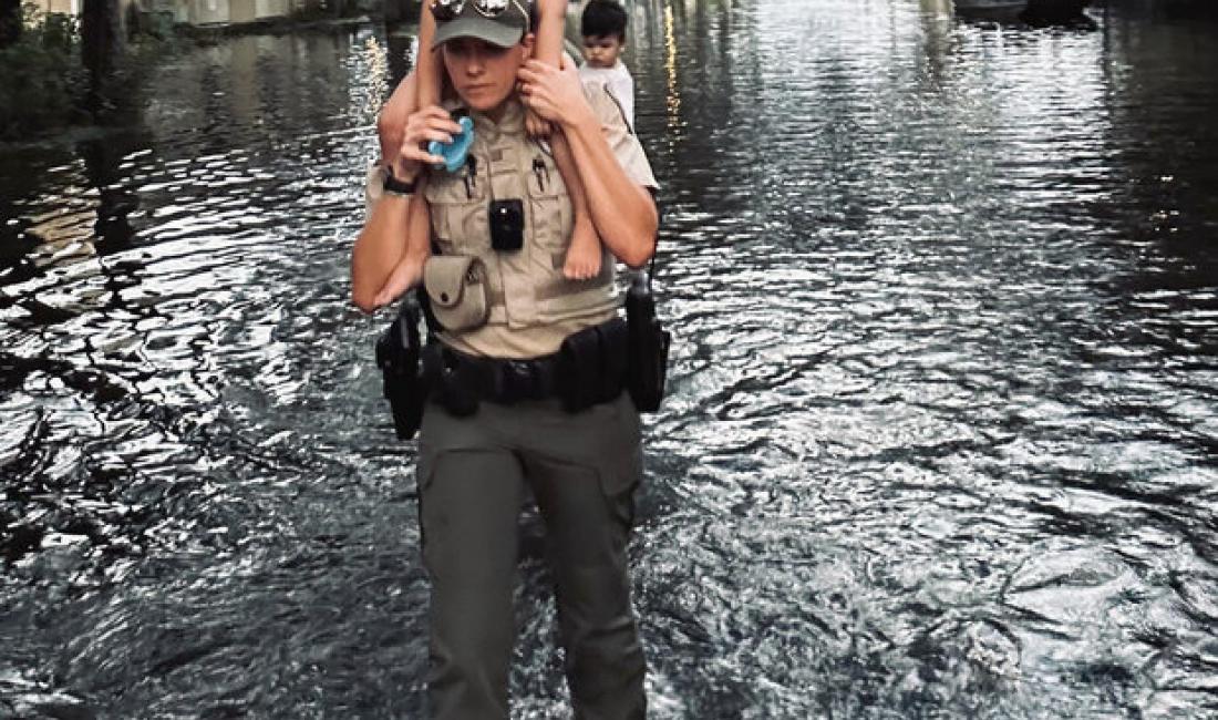 A Florida Fish and Wildlife officer helps to evacuate a flooded Florida neighborhood in the aftermath of Hurricane Milton on October 10, 2024. Florida Fish and Wildlife photo from their Flickr account. Image has been cropped and brightened. Used under a Creative Commons license.