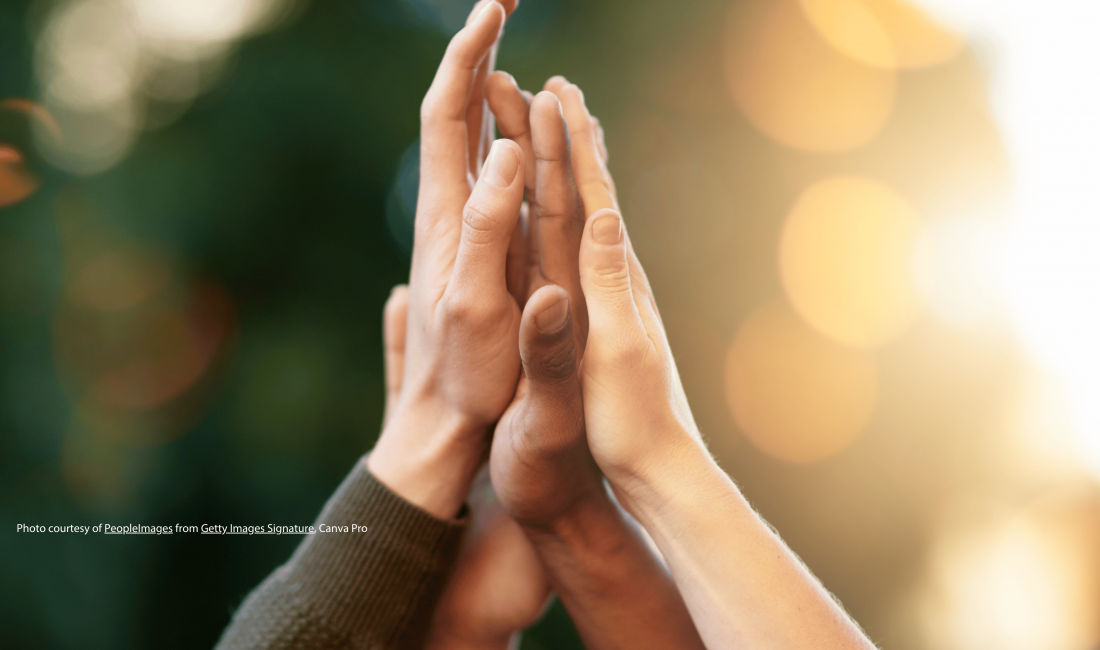 Diverse group of people giving each other high five