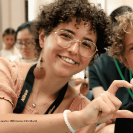 Photo of 2 young people shaping heart with their hands