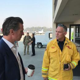 Photo from Public Domain: https://itoldya420.getarchive.net/amp/media/gavin-newsom-speaks-with-a-cal-fire-representative-during-the-kincade-fire-28def9