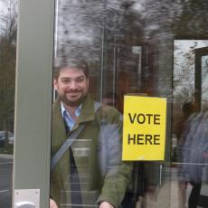Rafael Pineiro, board member of Democracy International, leaves a polling station in Kansas during the 2014 US midterm elections, with several ballot measures.