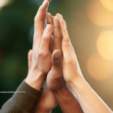 Diverse group of people giving each other high five